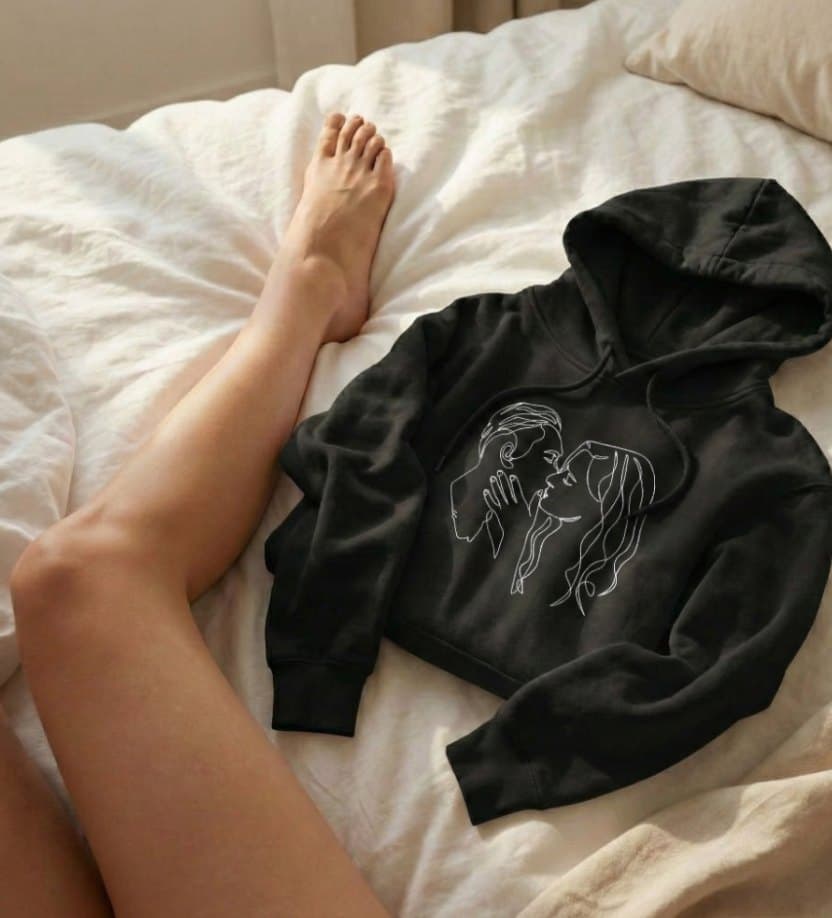 A black hoodie with a custom one-line portrait.