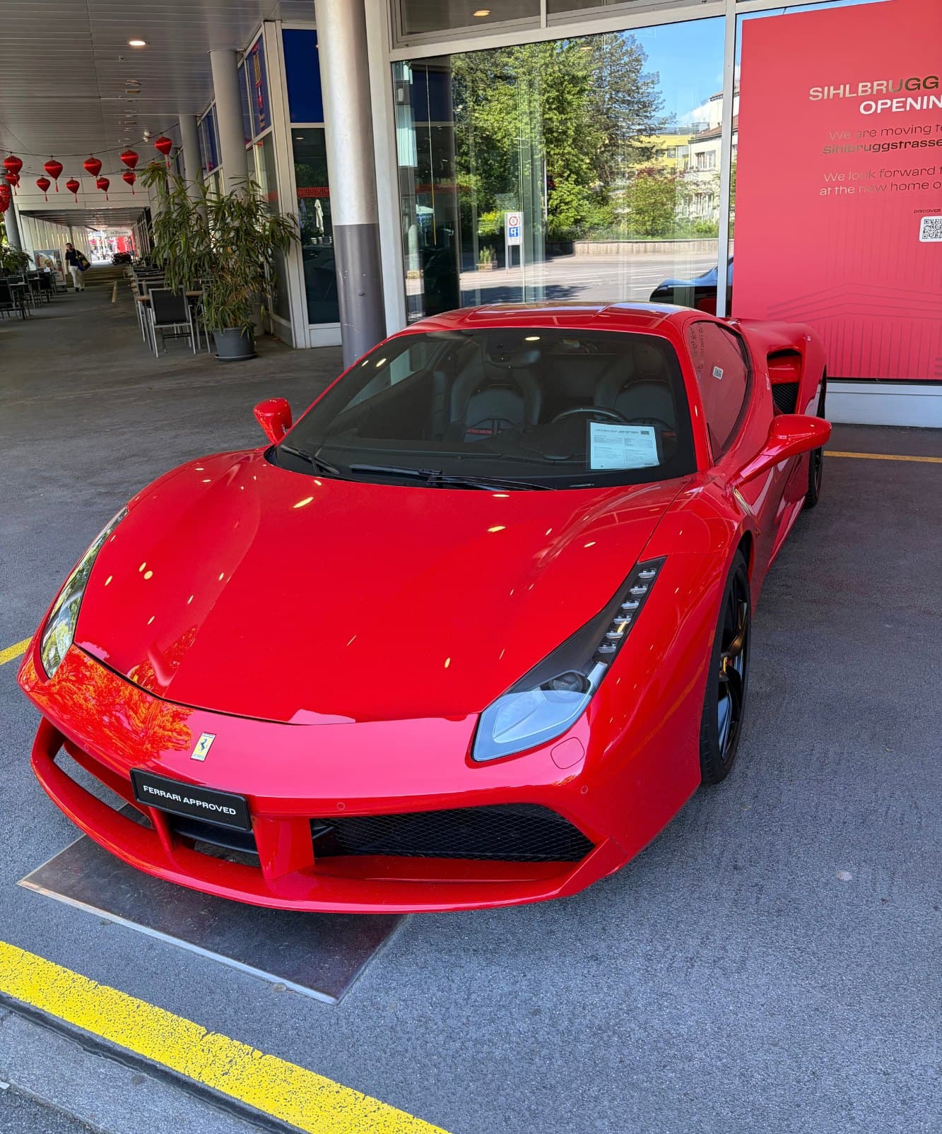 A red Ferrari 488 parked at my local dealer.